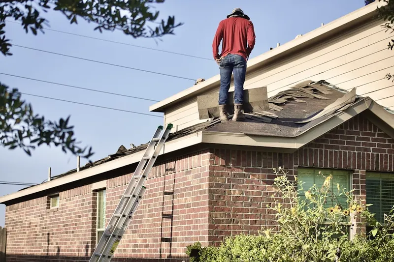 Professional roofer working on a residential roof in Gravely